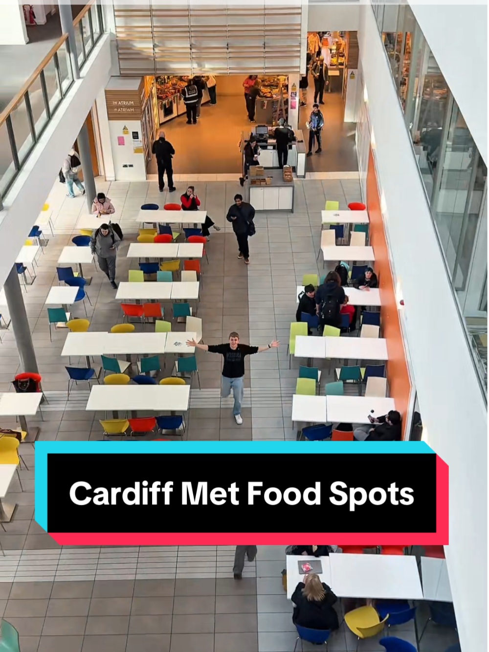 A top-down view of the Atrium in the Cardiff School of Management, with the digital caption 