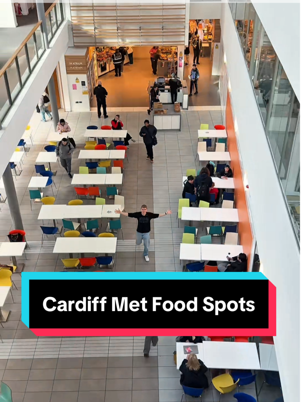 A top-down view of the Atrium in the Cardiff School of Management, with the digital caption 
