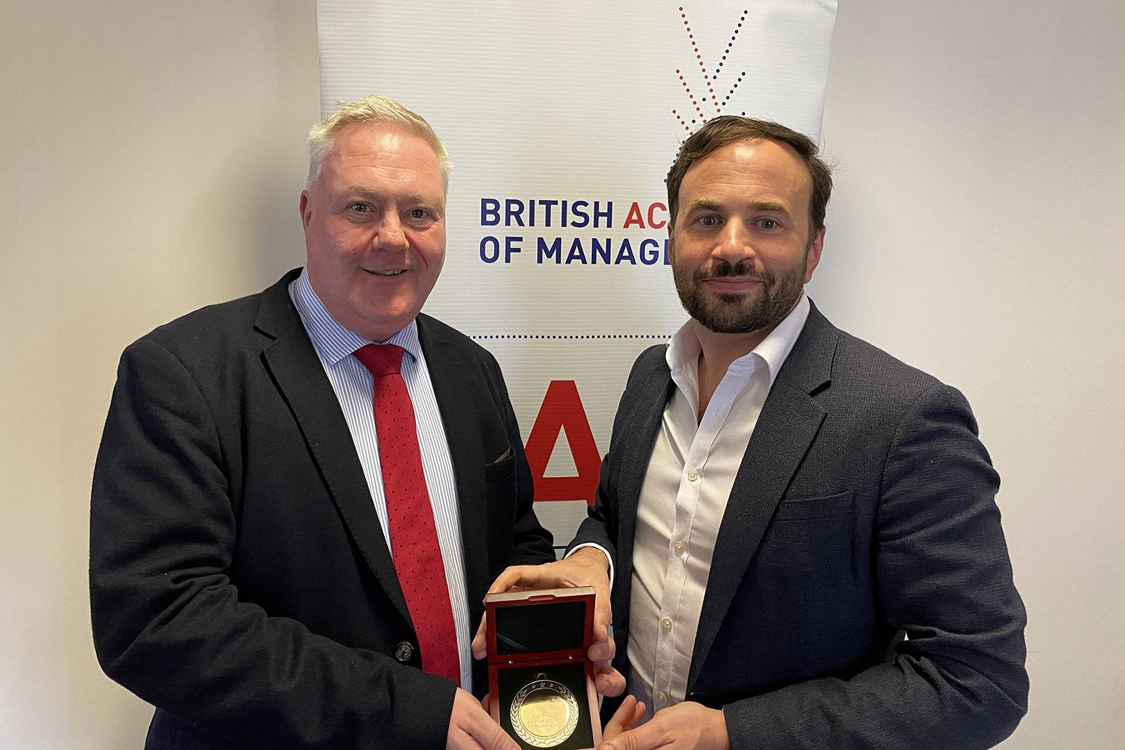Keith Glanfield receiving a medal from the British Academy of Management