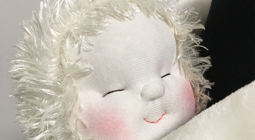 A close up of the HUG device with it's smiling face