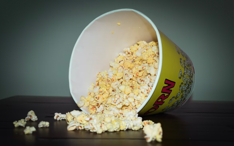 An overflowing popcorn bucket