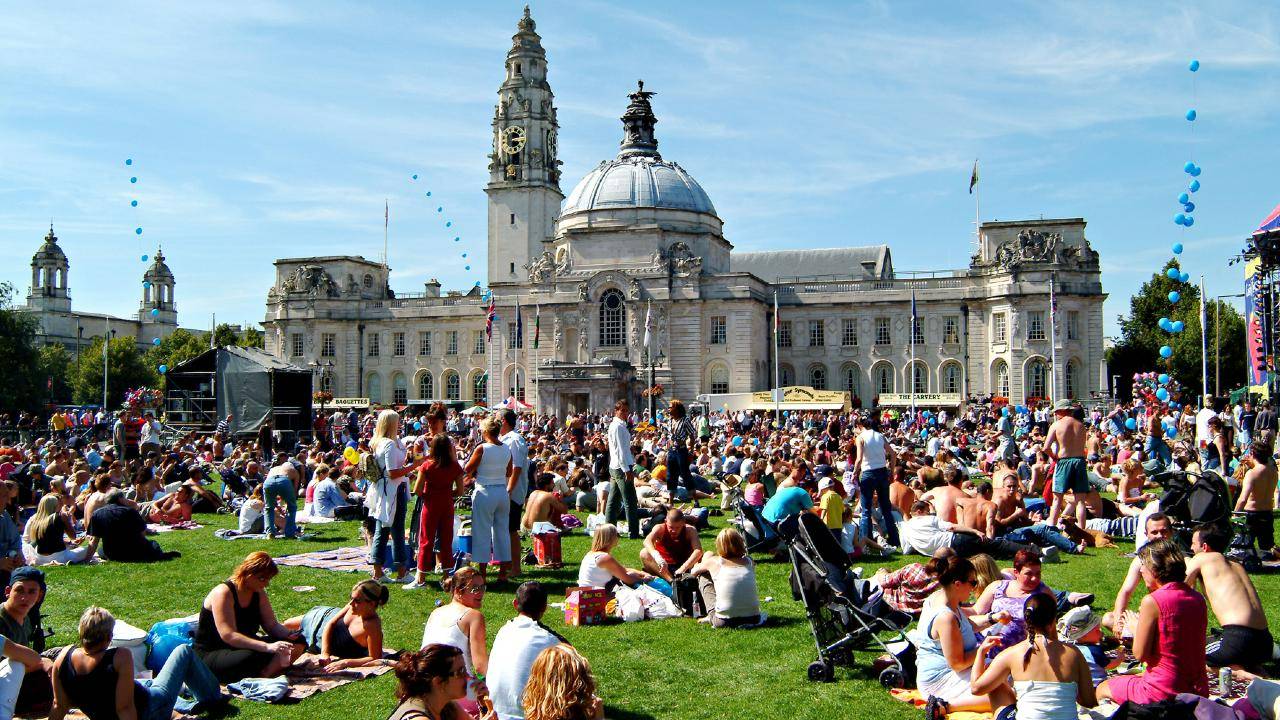 Crowds on grass in front of Cardiff City Hall